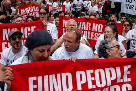 people hold anti-war banners