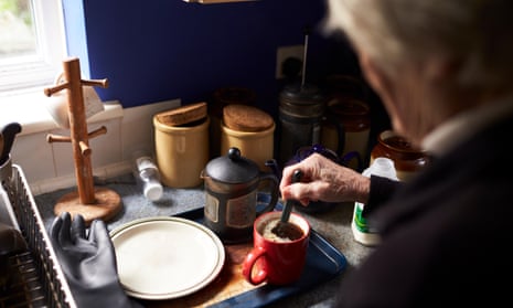 An older person making a drink at home