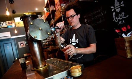 Venezuelan Xavier Losada, 36, works at his bar in Madrid.