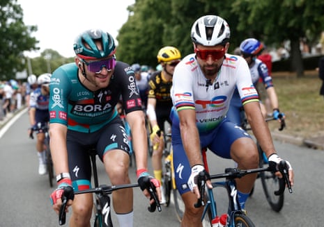 Peter Sagan chatting to Jordi Meeus (Bora–Hansgrohe) as they roll through the stage 21 of the Tour de France.