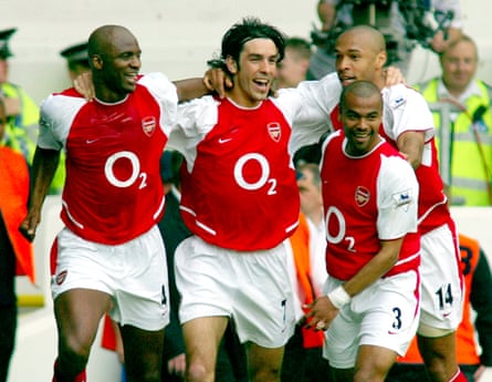 Arsenal players celebrate on their way to winning the title in 2004.