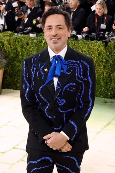 A man in a black suit embellished with blue crystals