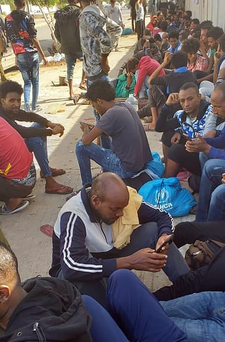 Hundreds of migrants who fled a detention centre in coastal Libya crowd around a UN facility in Tripoli