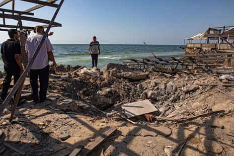 Palestinians inspect the site of an Israeli airstrike that targeted Al-Baqa Cafe, located on the seafront of Gaza City in the western part of the city, 30 June 2025.