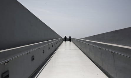 Visitors walk on a corridor leading to the top of the new National Museum of Contemporary Art in Athens.