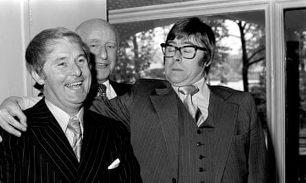 Black and white photo of Yarwood wearing Eric Morecambe style glasses and pulling a characteristic expression, with his arm around Ernie Wise.