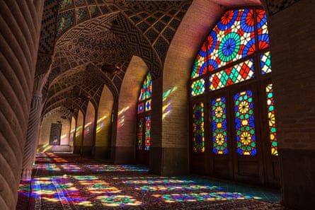 Stained-glass windows cast kaleidoscopic patterns on the floor of Nasir ol Molk mosque, or the Pink Mosque, in Shiraz.
