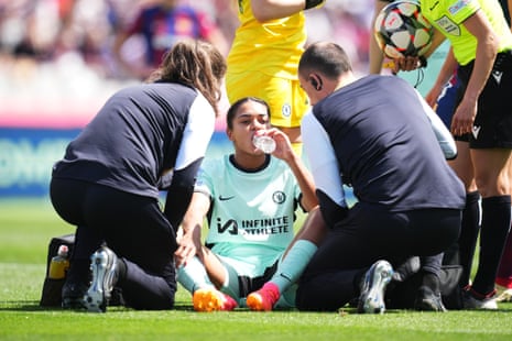 Jess Carter of Chelsea receives medical treatment during the Women's Champions League 2023/24 semi-final first leg between Barcelona and Chelsea.
