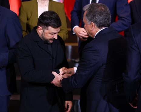 Ukraine’s president Volodymyr Zelenskiy and U.S. special envoy Steve Witkoff shake hands as they gather for a family photo at the Chancellery in Berlin, Germany.