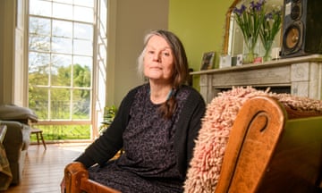 Davina Ware wearing black sitting on chair with her body facing the camera