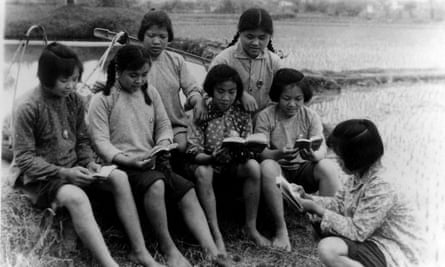 Peasants study Chairman Mao’s quotations in the Little Red Book - the ‘bible’ of the Cultural Revolution during a break from rice planting, 1970, Guangxi, China.