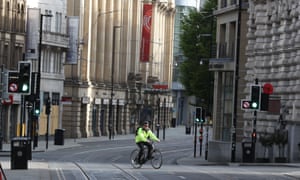 A cyclist in an empty Manchester street last month
