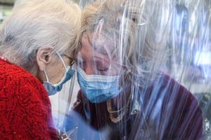 Venice, Italy. A resident of the Domenico Sartor nursing home in Castelfranco Veneto hugs her visiting daughter through a plastic screen