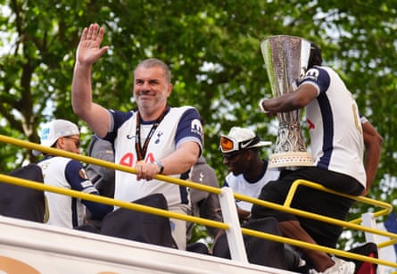 Ange Postecoglou waves to fans on the open-top team bus during the Europa League winners parade in north London