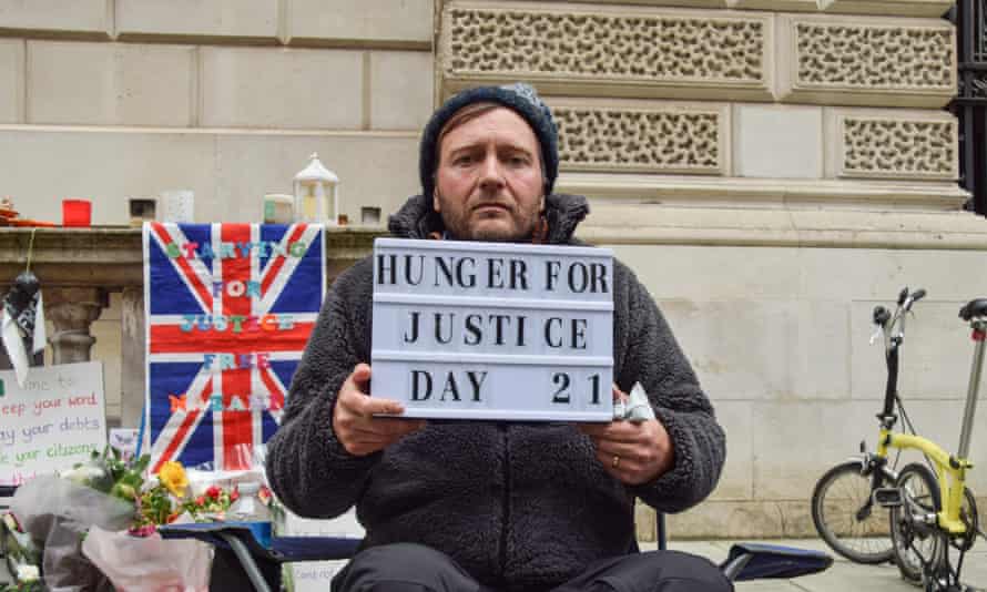 Richard Ratcliffe, the husband of British-Iranian aid worker Nazanin Zaghari-Ratcliffe, holds a ‘Hunger For Justice’ sign on the 21st and final day of his hunger strike outside the Foreign, Commonwealth &amp; Development Office in Whitehall, calling on the UK government to do more to help with her release. Taken on 13 November.