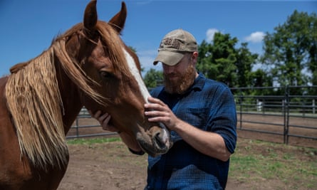 Phil Wytrwa spends time with a mustang named Tango.