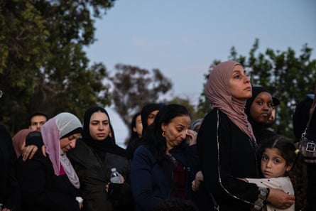 A group of women with a childbow their heads in sorrow