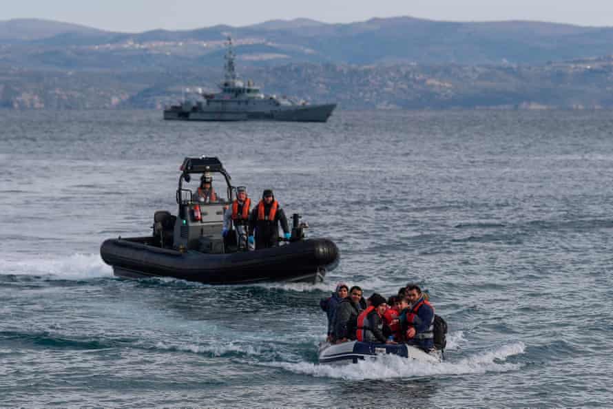 A dinghy with 15 Afghan refugees, 5 children, 3 women and 7 men, approaches the Greek island of Lesbos on February 28, 2020 next to UK Border Force patrol boat HMC Valiant (background), a cutter patroling in Agean sea under European Union border force Frontex. - The head of the European Union’s border and coast guard agency faces a grilling on Tuesday, Dec. 1, 2020 by EU lawmakers as pressure mounts over allegations that Frontex was involved in illegal pushbacks aimed at preventing migrants or refugees entering Europe through the Greek islands.
