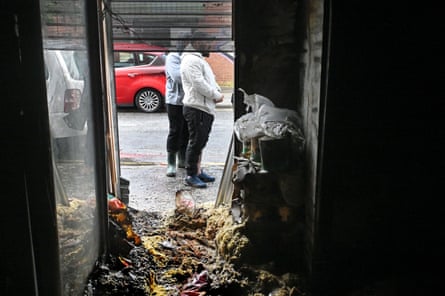 Two men outside the remains of a shop in south Belfast