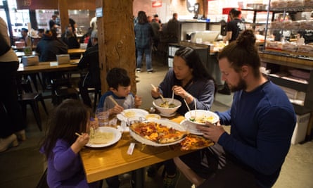 Family eating ramen and pizza at Pine Steet Market