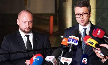 Jacek Siewiera, head of Poland’s national security office (left), and government spokesperson Piotr Müller make a statement after a crisis meeting in Warsaw on Tuesday evening.