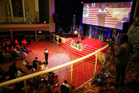 A television cameraman films Pastor Andrew Adeleke as he addresses the congregation during the ‘Super Sunday’ service..