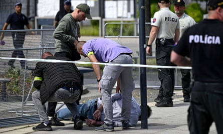 Police arrest a man who has been restrained on the floor
