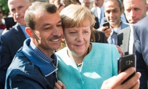 An asylum seeker takes a selfie with the German chancellor, Angela Merkel, in 2015.