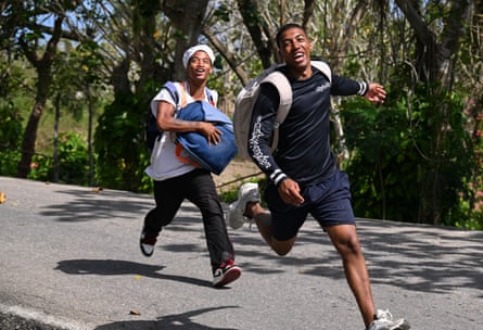 two men smile while running