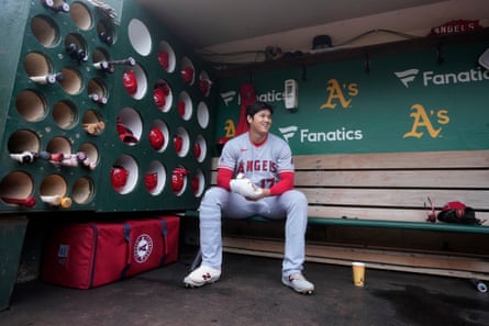 The Angels’ Shohei Ohtani sits in the dugout before the team’s baseball game against the Athletics on 2 September in Oakland.