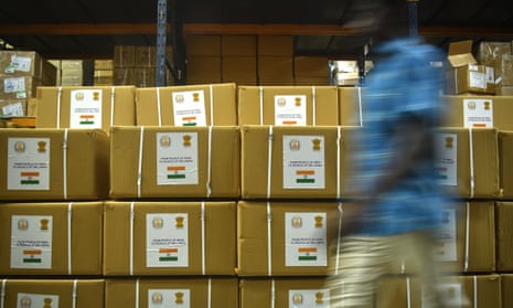 An Indian worker walks past the packages of essential medicines that are being shipped to Sri Lanka amid the country's ongoing economic crisis