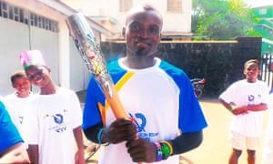 Jimmy Thoronka holds the Commonwealth Games baton in Sierra Leone.