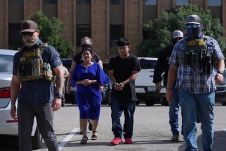 federal agents escort a family