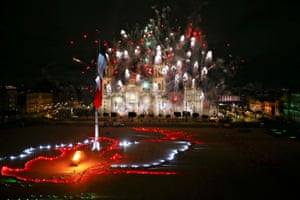 Mexico City, Mexico. Fireworks explode over the Metropolitan Cathedral and National Palace as Mexico celebrates the 210th anniversary of its independence from Spain