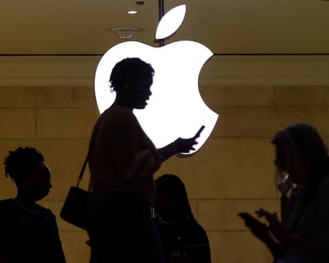 Silhouette of women using phones in an Apple store