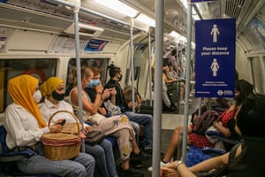 People travelling on the London Underground on 1 August, 2020 are wearing facemasks, which has become mandatory on public transport where social distancing is not possible. Passenger numbers are now rising as the government has eased lockdown restrictions and encouraged people to go to work.