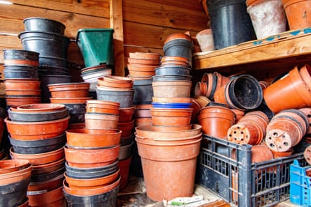Piles of plastic flower pots in a garden shed