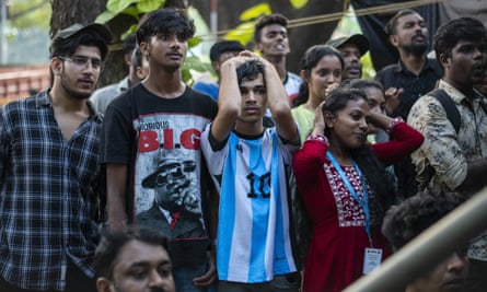 A supporter of Argentina watches the opening-game loss to Saudi Arabia on 22 November 2022.