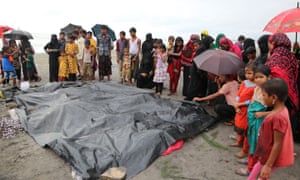 People gather around the dead bodies of Rohingya children who had died after their boat capsized off Teknaf, Bangladesh.