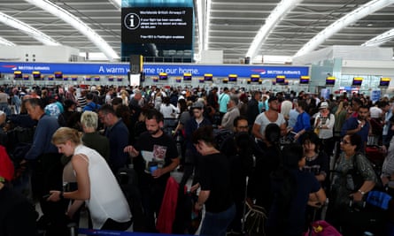 People wait with their luggage at Heathrow Terminal 5 in London.