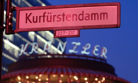Sign reading Kurfürstendamm above a shop on a street in Berlin.