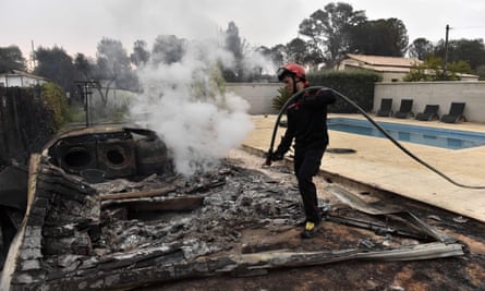 A firefighter puts out a fire next to a swimming pool