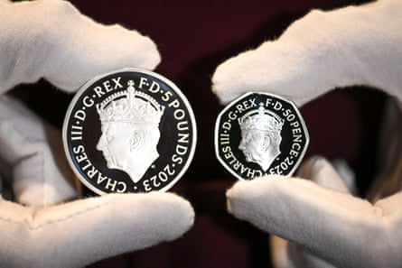 The Royal Mint display their Coronation commemorative £5 coin and 50 pence coin to mark the Coronation of King Charles III.