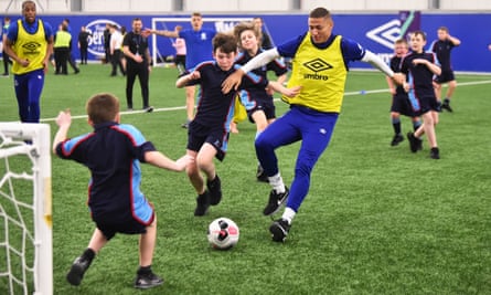 Richarlison takes on some youngsters during an Everton In The Community showcase event at Finch Farm in February.