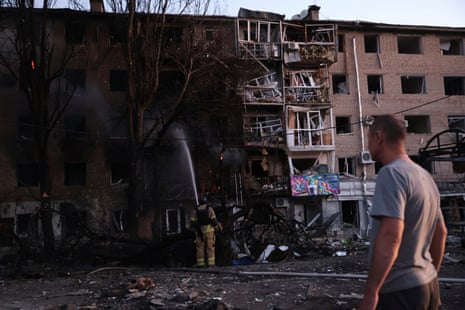 A resident looks at his destroyed home as the fire service work after a Russian airstrike in Zaporizhzhia, on Saturday.
