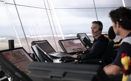 Air-traffic controllers Anwar Newkirk and Michael Baker in the Melbourne airport control tower.