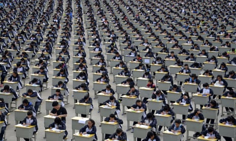 Students take an examination in a playground at a high school in Yichuan, Shaanxi province. 
