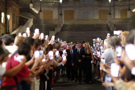 Rory McIlroy and his wife Erica Stoll walk through fans at the Spanish Steps in Rome prior to the 2023 Ryder Cup