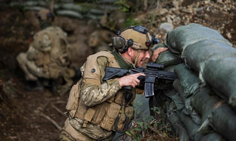 Ukrainian soldiers take part in a blank firing exercise with Norwegian national guard instructors.