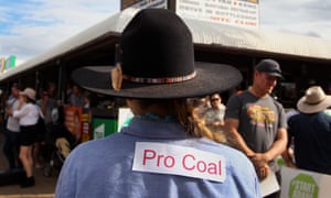A coalmining supporter wears a ‘Pro Coal’ sign on her shirt on Saturday in Clermont, central Queensland, as the Stop Adani Convoy rolls through town.